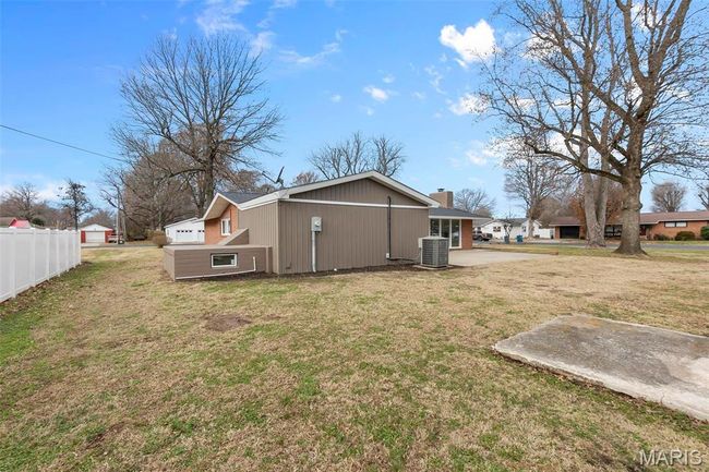 Back of house with a lawn and central air condition unit | Image 4