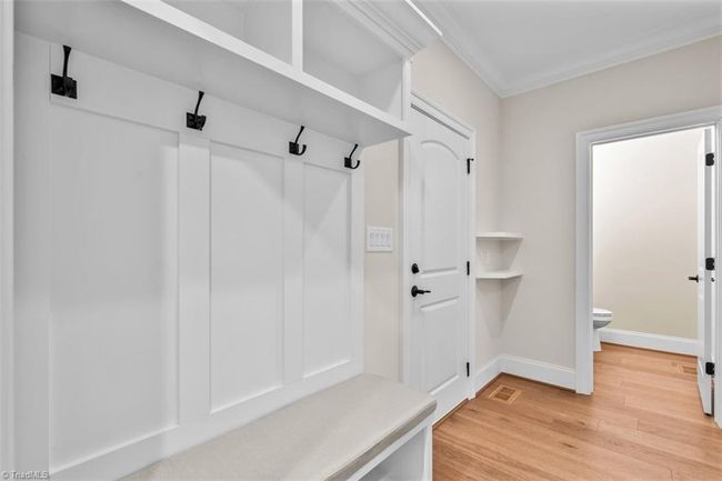 Drop zone and view of half bath off of garage. | Image 20