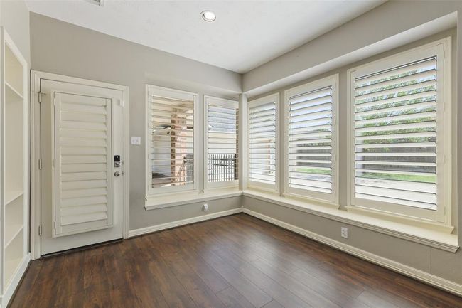 Breakfast room is open, and leads out to a large covered porch. | Image 15