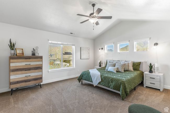 Primary Bedroom with vaulted ceilings, attached bedside lighting, and a ceiling fan | Image 26