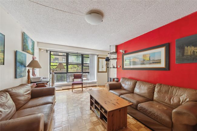 Living area with a baseboard radiator and a textured ceiling | Image 7