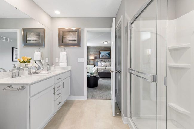 (Photo of a decorated model, actual homes finishes will vary) An extension of the owner's suite, this private and spacious bath contains a double-vanity, a linen closet and a shower. | Image 11