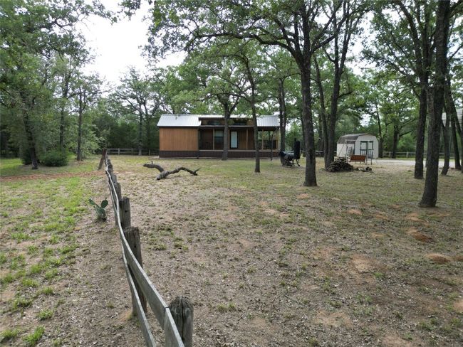 View of yard with a storage shed | Image 14