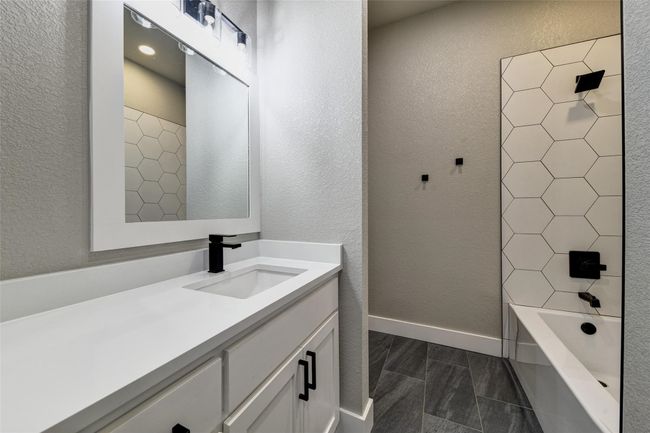 Bathroom with vanity and washtub / shower combination | Image 24