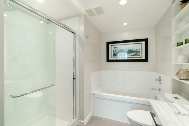 Bathroom with toilet, a bath, a stall shower, tile patterned floors, and recessed lighting | Image 22