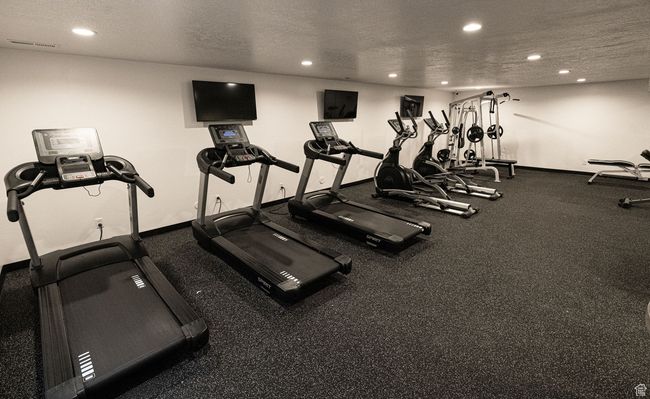 Exercise room with recessed lighting and a textured ceiling | Image 17