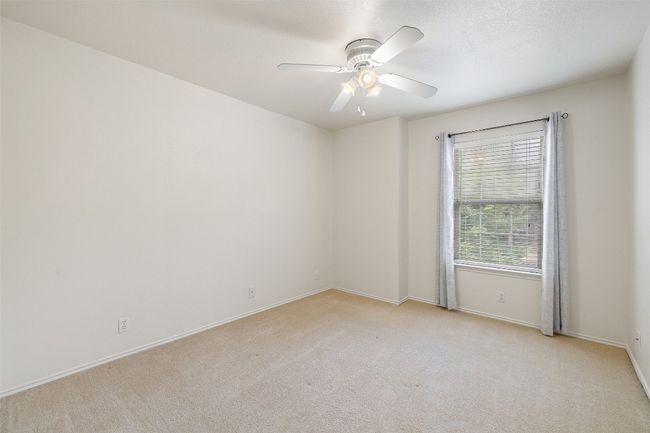 Unfurnished room featuring ceiling fan, light colored carpet, and baseboards | Image 35