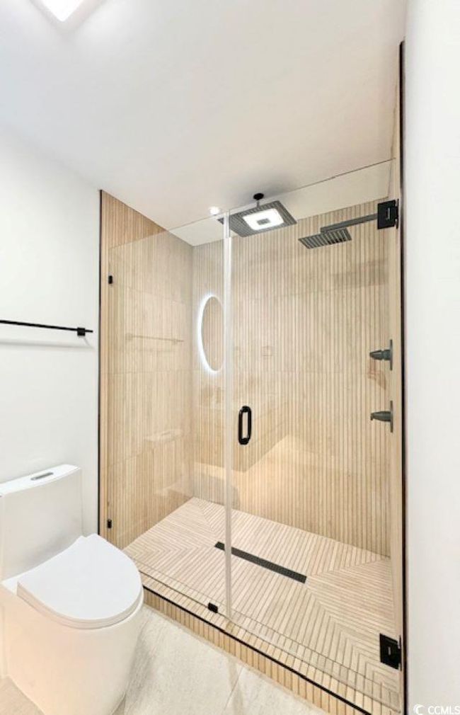 Full bathroom featuring a shower stall and tile patterned flooring | Image 22