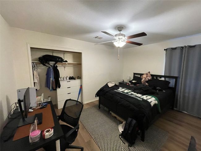 Bedroom featuring wood finished floors and a ceiling fan | Image 5