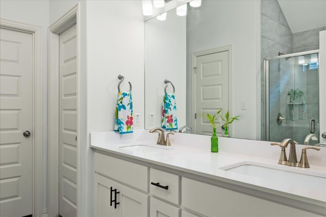 Bathroom featuring double vanity, a stall shower, and a sink | Image 21