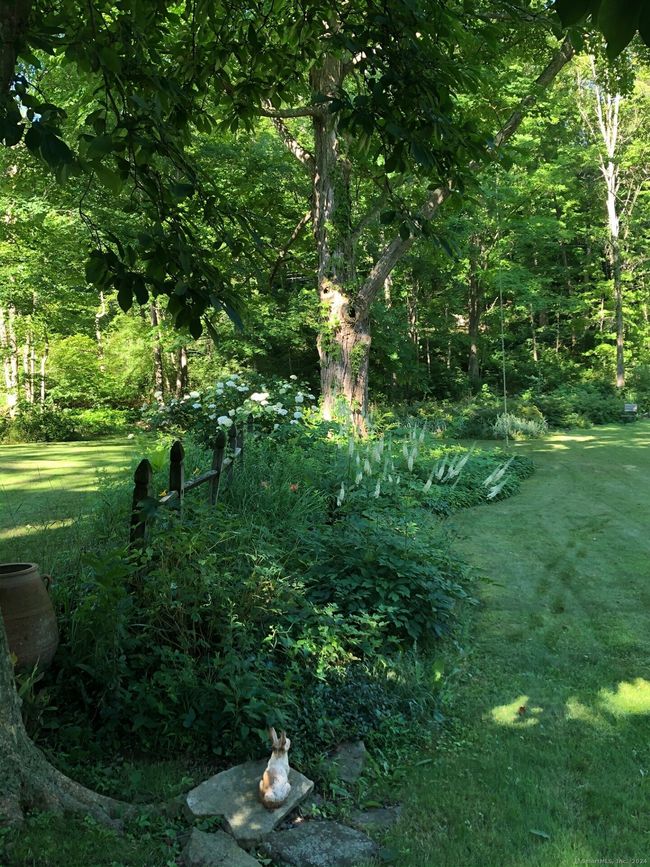Summer view of the fence in the front yard with hydrangeas and perennials in bloom | Image 13