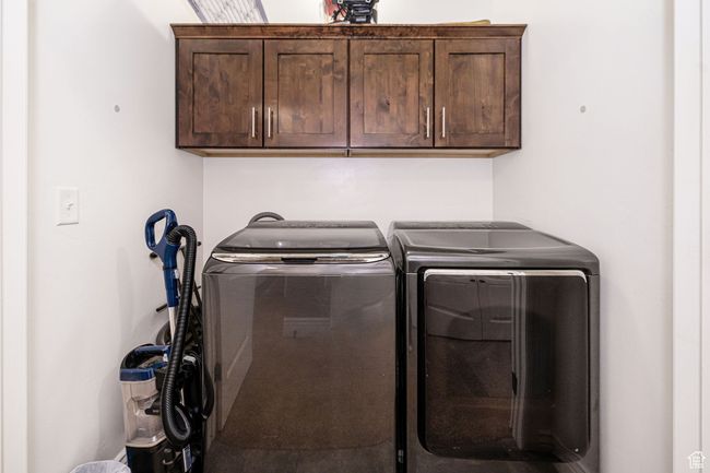 Washroom with washer and clothes dryer and cabinet space | Image 17