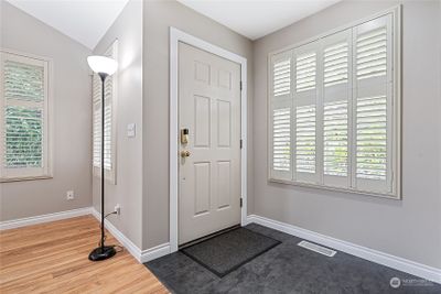 Welcoming entrance with custom shutters throughout the living room. | Image 2