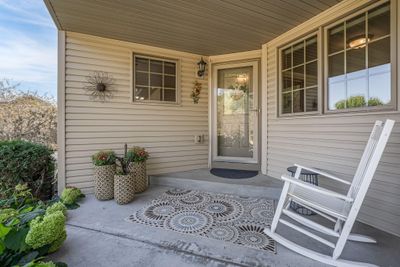 A welcoming front porch and sidewalk bordered with expertly designed landscaping. | Image 2