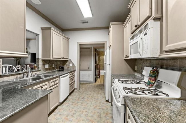 Just down the upstairs hallway is a are separate guest quarters with full kitchen, two bedrooms and full bath that is also accessible through a separate entrance on the front of the home. | Image 41