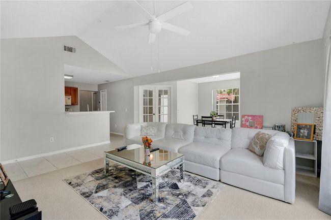 The open floor plan where you can see the kitchen, dining room and a bedroom | Image 7