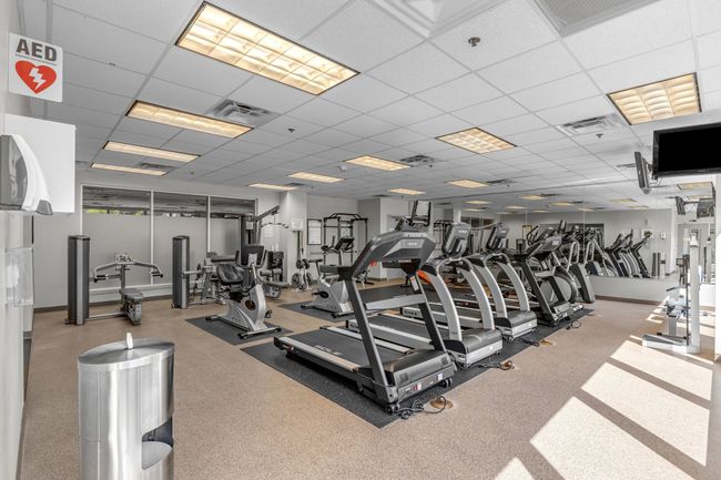 Gym featuring baseboards, a paneled ceiling, and visible vents | Image 22