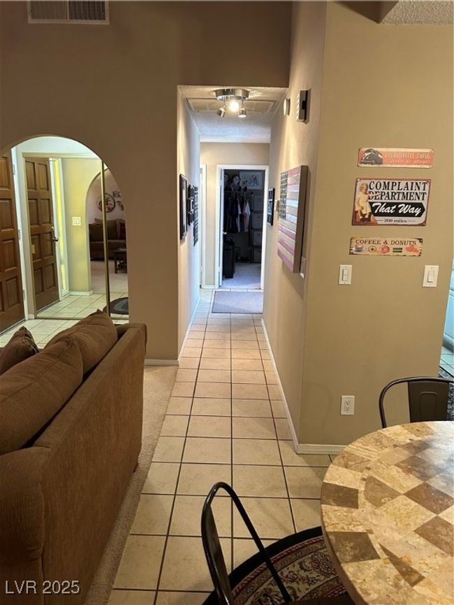 Hallway with light tile patterned flooring and arched walkways | Image 26