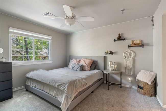 Carpeted bedroom with baseboards, ceiling fan, and visible vents | Image 29