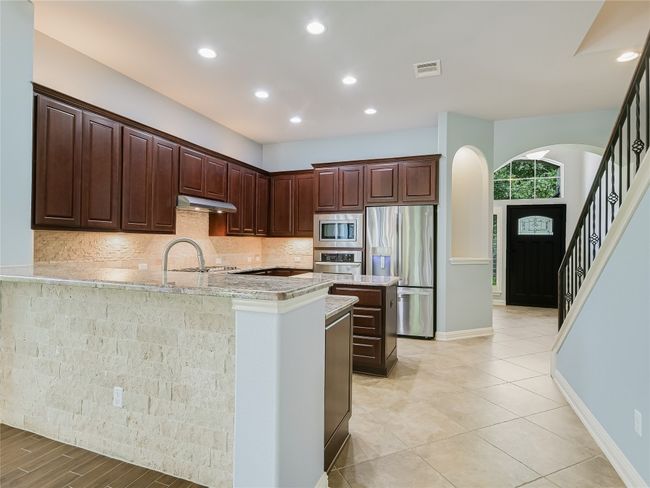 Add stools here for some additional breakfast dining space. Refrigerator conveys! | Image 6