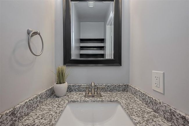 An updated half bath is convenient for downstairs guests | Image 14