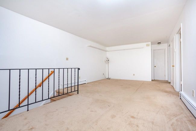 Livingroom featuring carpet floors and baseboard heating | Image 6