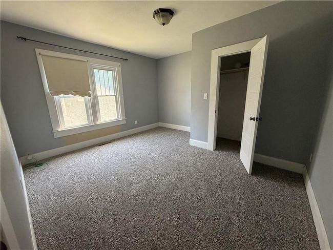 Unfurnished bedroom with carpet flooring and a closet | Image 38