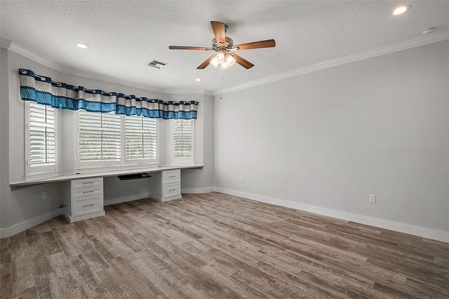 Primary bedroom has a built in desk | Image 15