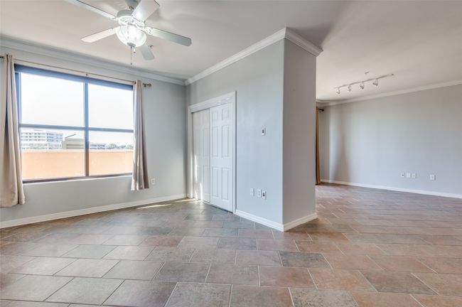 Study with crown molding, ceiling fan and view of large private balcony | Image 20