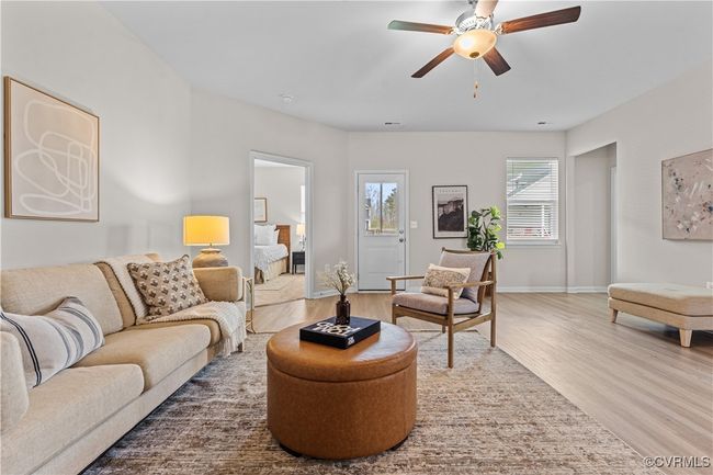 Living area with wood finished floors, ceiling fan, and baseboards | Image 20