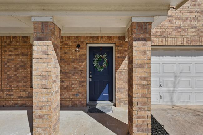 View of exterior entry with brick siding | Image 6