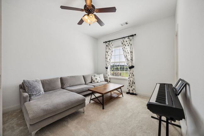 Living area with light colored carpet and ceiling fan | Image 22