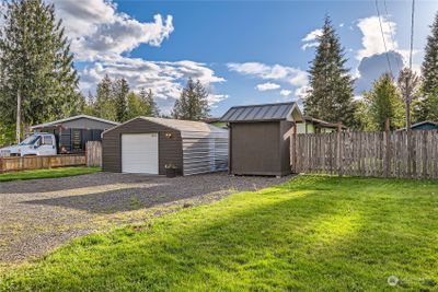 Front of home is private, has a detached garage and a storage shed | Image 2