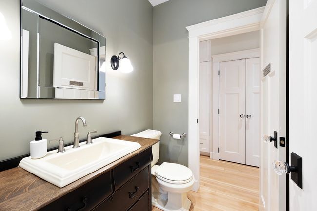 Bathroom featuring toilet, vanity, and wood finished floors | Image 9