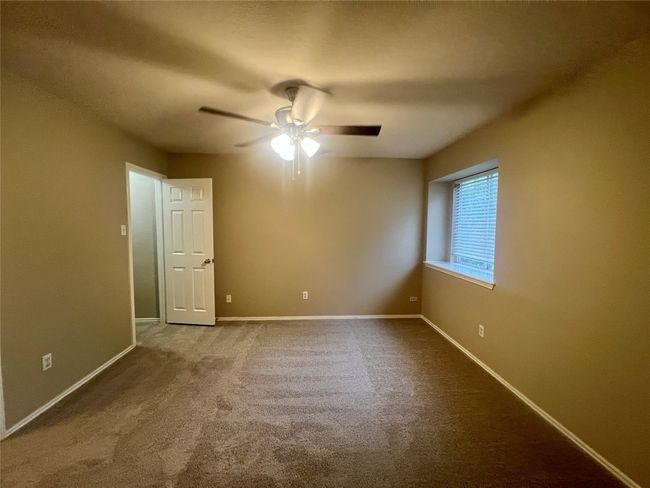 Carpeted spare room with a ceiling fan and baseboards | Image 29