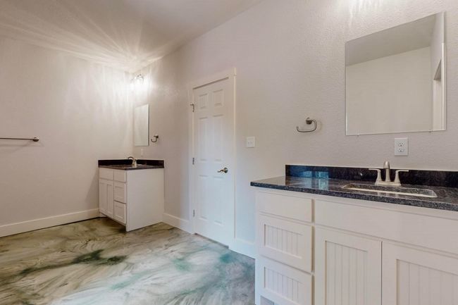 Full bathroom featuring two vanities and baseboards | Image 26
