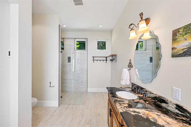 Bathroom with healthy amount of natural light, vanity, a stall shower, and recessed lighting | Image 82