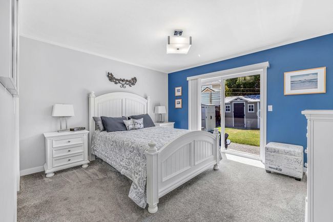 Bedroom featuring access to exterior, carpet flooring, and baseboards | Image 18