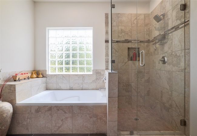 Unwind in your bath or shower underneath the high powered shower, seamless shower door. | Image 21