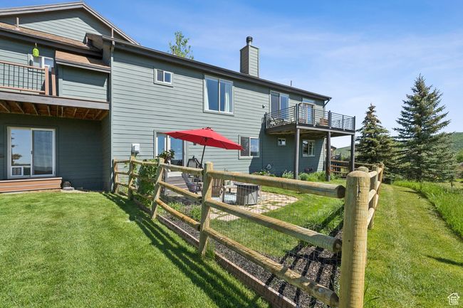 Back of house featuring a chimney and a balcony | Image 45
