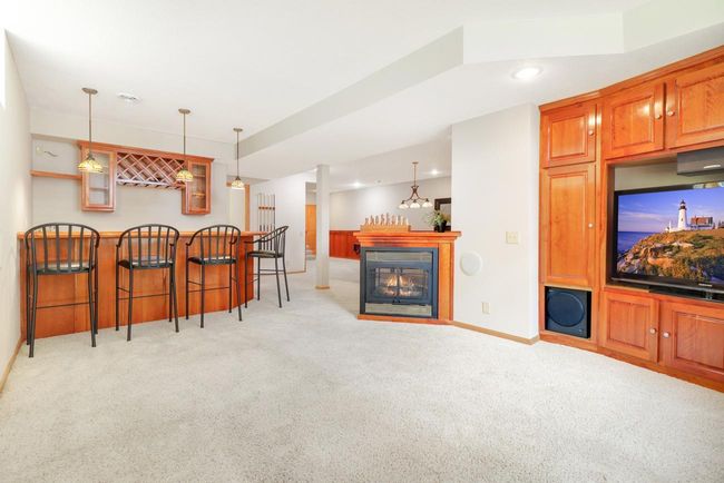 Family room with bar & gas fireplace | Image 28
