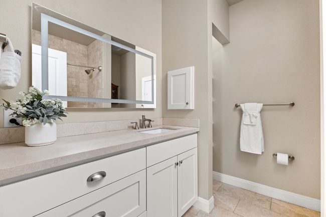 The guest bathroom features modern finishes and a clean, timeless design to ensure a comfortable stay for visitors. | Image 22