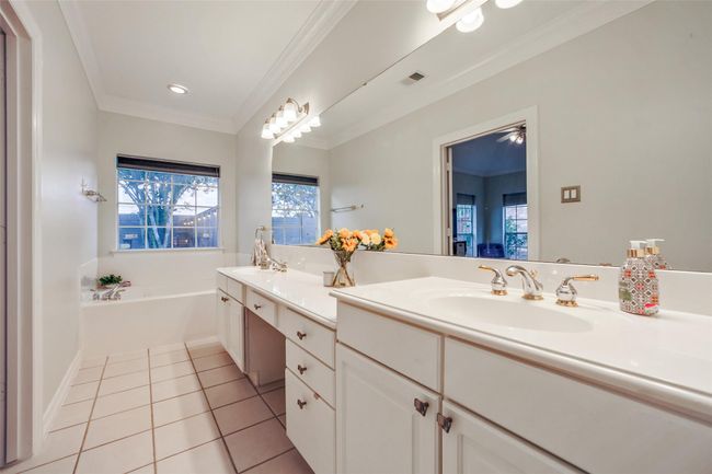 Primary bathroom with jetted tub, shower, double sink vanity and spacious closet. | Image 17