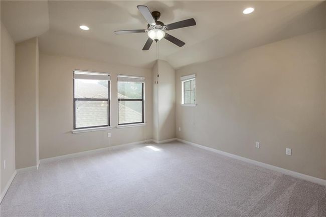 Empty room featuring light colored carpet, a ceiling fan, recessed lighting, and vaulted ceiling | Image 23
