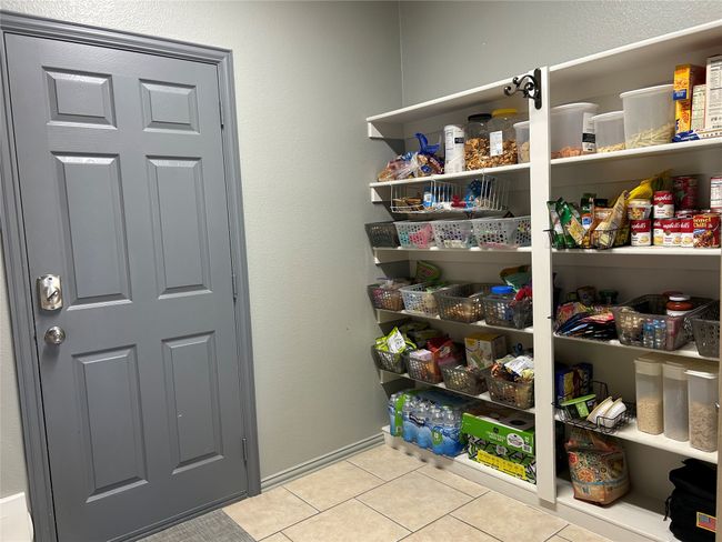 View of pantry that is opposite of the washer & dryer. | Image 15