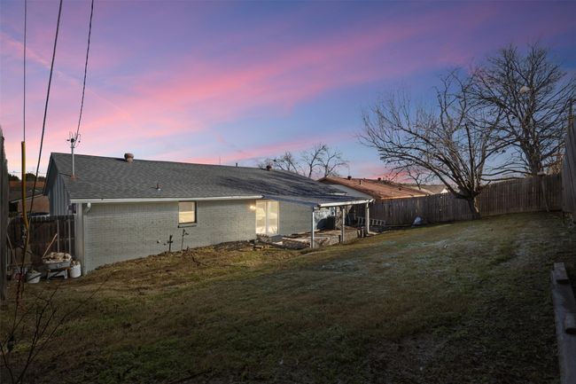Back house at dusk featuring a lawn | Image 25