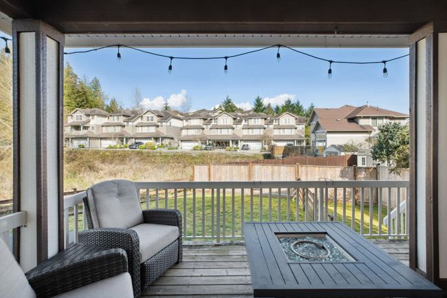 Wooden terrace with a yard, outdoor dining space, and a residential view | Image 38