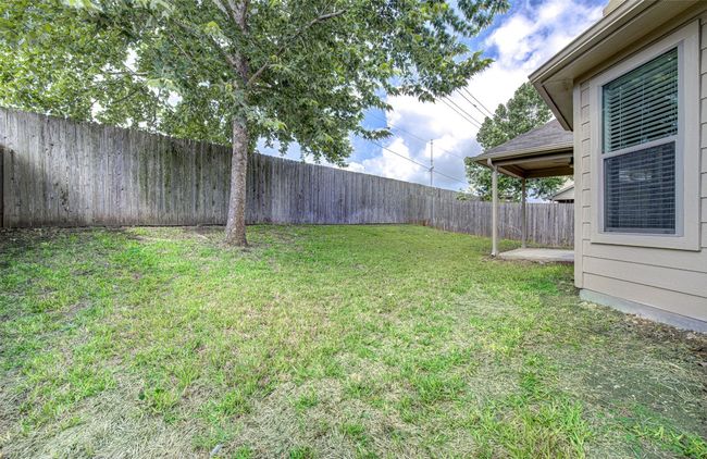 View of fenced backyard | Image 26