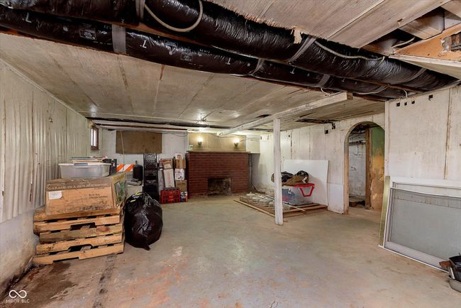 unfinished basement with a fireplace | Image 25
