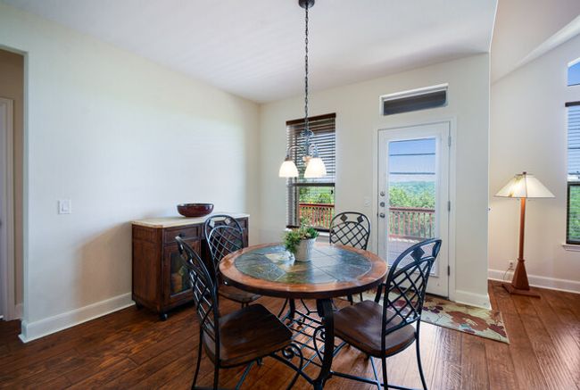 Dining room with dark wood finished floors, healthy amount of natural light, and baseboards | Image 8